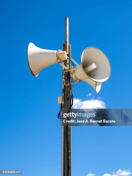 civil defense siren tower on the street against a blue sky. - tower speakers stock pictures, royalty-free photos & images