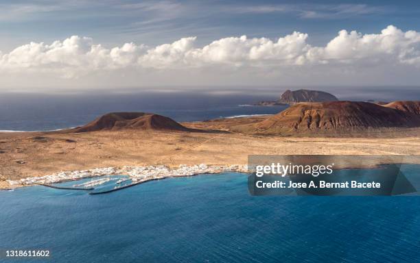 elevated view of a volcanic island in the atlantic ocean at sunset. . graciosa island, canary islands, spain. - biosphere planet earth stock pictures, royalty-free photos & images