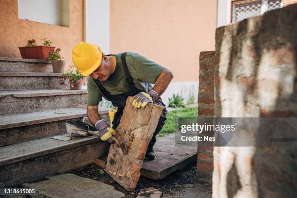 a construction worker installs bricks - brick masonry stock pictures, royalty-free photos & images