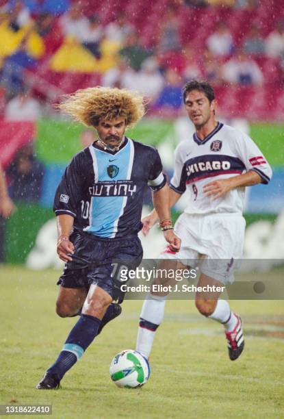 Carlos Valderrama, of Colombia and Midfielder for the Tampa Bay Mutiny runs with the football past Ante Razov of the Chicago Fire during their MLS...