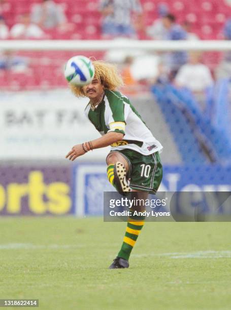 Carlos Valderrama, of Colombia and Midfielder for the Tampa Bay Mutiny strikes the football upfield during the MLS Eastern Conference match against...