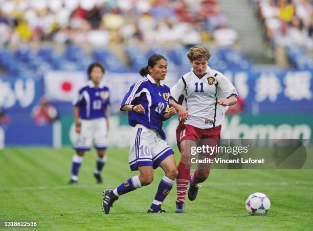 Olga Letyushova, Forward for Russia challenges Homare Sawa, Captain and Midfielder for Japan during their Group C match of the FIFA Women's World Cup...