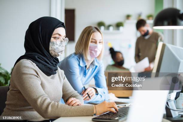 multi ethnic business team in office, wearing face masks - employee engagement mask stock pictures, royalty-free photos & images