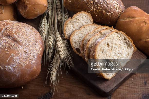 close-up of breads on table - whole wheat bread loaf stock pictures, royalty-free photos & images