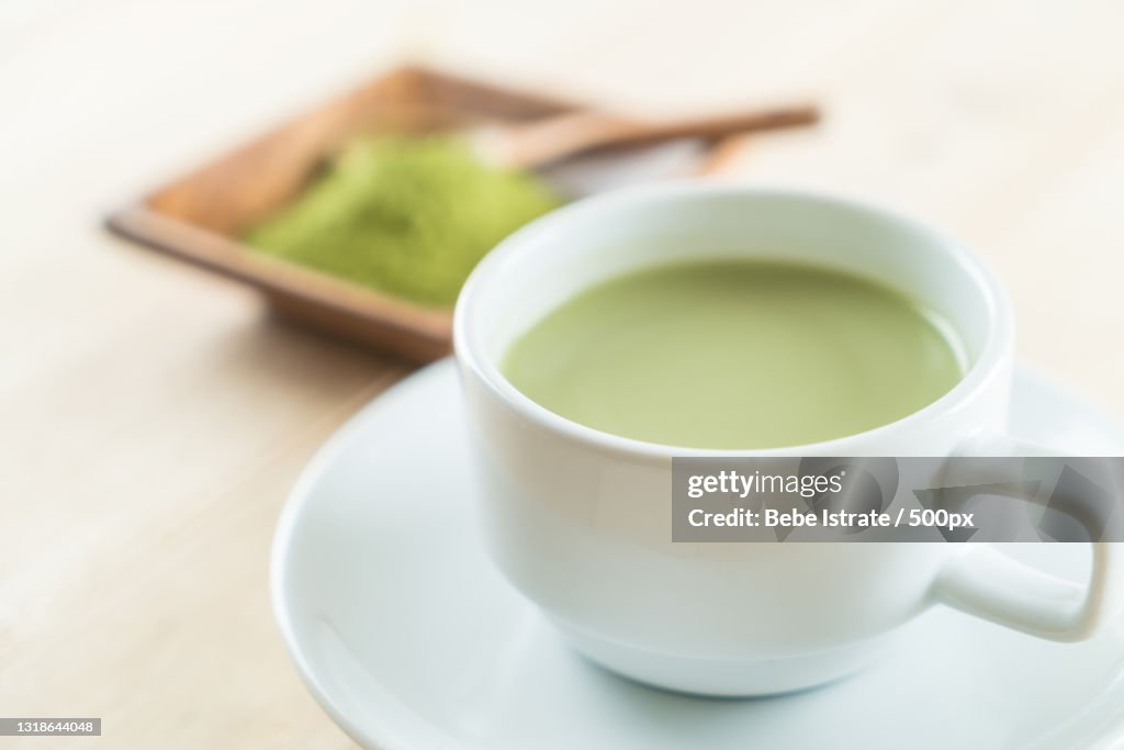 Close-up of tea cup and leaves on table