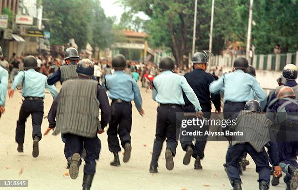 Police charge protesters June 4, 2001 in Katmandu, Nepal. King Gyanendra, the brother of slain King Birendra, was sworn in after Crown Prince...