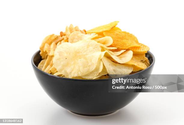 close-up of potato chips in bowl against white background - bowl foto e immagini stock