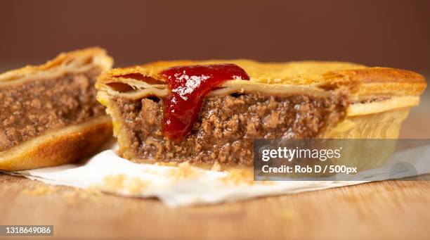 close-up of bread on cutting board - meat pie stock pictures, royalty-free photos & images