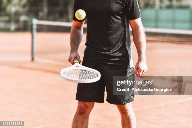 male tennis player bouncing ball on court - bouncing tennis ball stock pictures, royalty-free photos & images