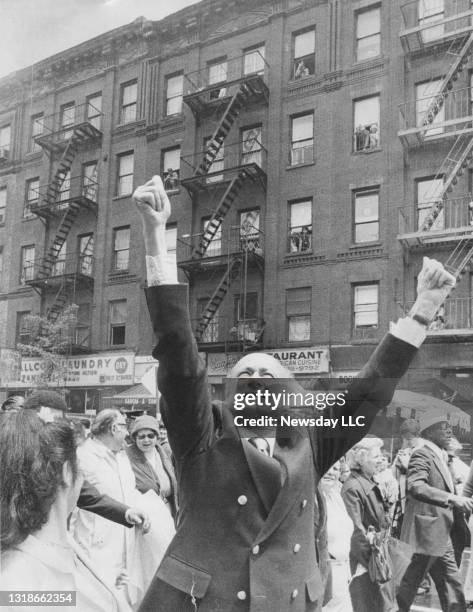 Mayor Ed Koch reaches to the sky to welcomes the sunshine at a street festival on 9th Avenue near 57th Street in Manhattan on May 18, 1980.