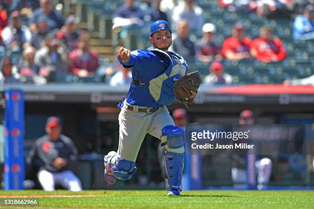 Catcher Willson Contreras of the Chicago Cubs throws out Andres Gimenez of the Cleveland Indians at first to end the second inning at Progressive...