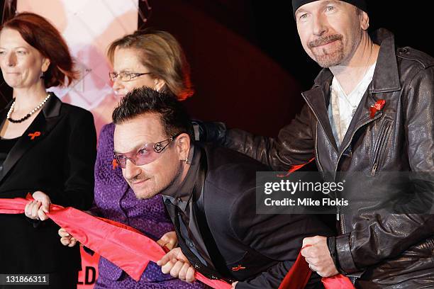 Prime Minister Julia Gillard, Chair of Pacific Friends of the Global Fund Wendy McCarthy, U2s Bono and The Edge pose after flicking the switch to...