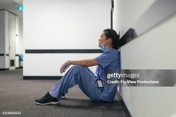 tired and stressed nurse - tired-healthcare-worker stock pictures, royalty-free photos & images