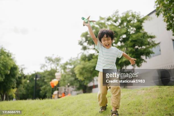 happy littler boy in garden. - asia kid imagens e fotografias de stock