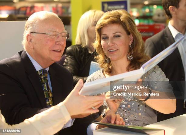 Former Belgian Prime Minister Marc Eyskens and Princess Martha Louise of Norway exchange each other's books at the Antwerp Book Fair on November 6,...