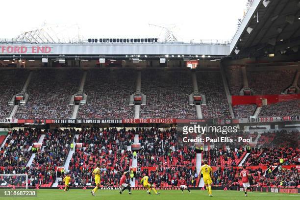 General view of play as fans watch on during the Premier League match between Manchester United and Fulham at Old Trafford on May 18, 2021 in...