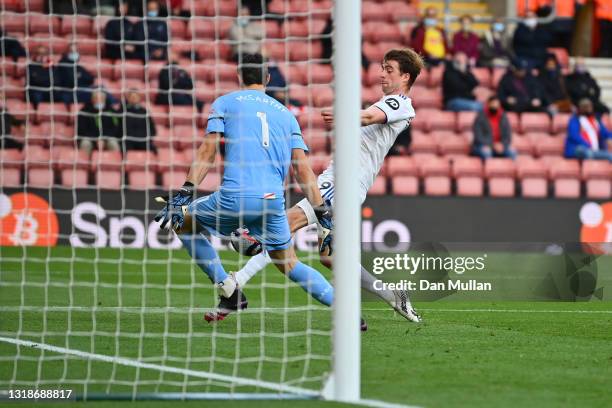 Patrick Bamford of Leeds United scores their sides first goal past Alex McCarthy of Southampton during the Premier League match between Southampton...