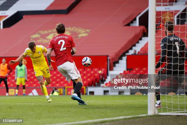 Joe Bryan of Fulham scores their side's first goal past David de Gea of Manchester United during the Premier League match between Manchester United...