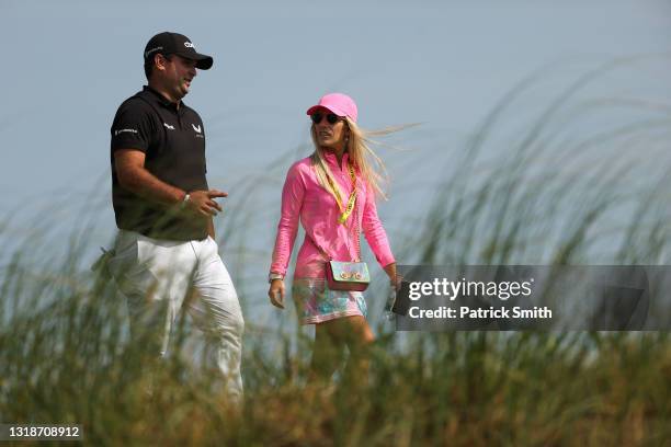 Patrick Reed of the United States walks with his wife Justine Reed during a practice round prior to the 2021 PGA Championship at Kiawah Island...