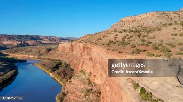 drone view of hiking couple on canyon ridge above river - fruita colorado stock pictures, royalty-free photos & images