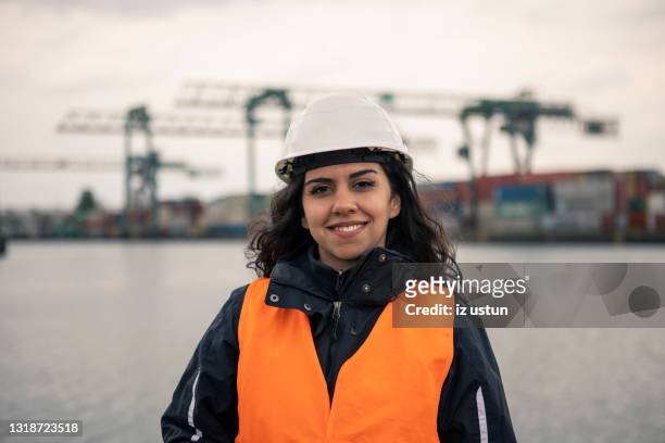 young dock worker woman - dockarbeiter stock-fotos und bilder
