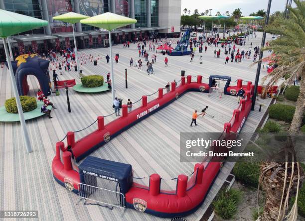 In an aerial view, fans arrive for the game between the Florida Panthers and the Tampa Bay Lightning as young hockey players pass the puck on an...