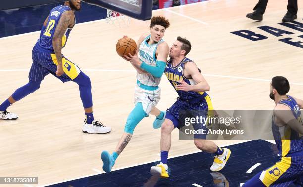 LaMelo Ball of the Charlotte Hornets dribbles the ball against the Indiana Pacers during the 2021 NBA Play-In Tournament at Bankers Life Fieldhouse...