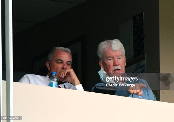 General manager Dayton Moore and owner John Sherman of the Kansas City Royals watch a game against the Milwaukee Brewers in the first inning at...