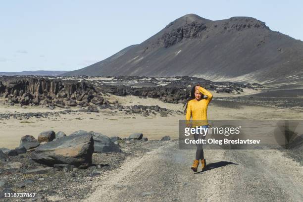freedom and escape. young stylish woman enjoying walk by icelandic highlands in sunny summer weather - volcanic landscape stock pictures, royalty-free photos & images