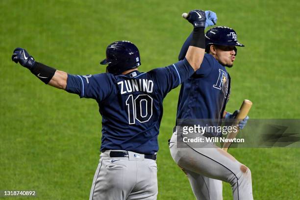Mike Zunino of the Tampa Bay Rays celebrates with teammate Willy Adames after hitting a two-run home run against the Baltimore Orioles during the...