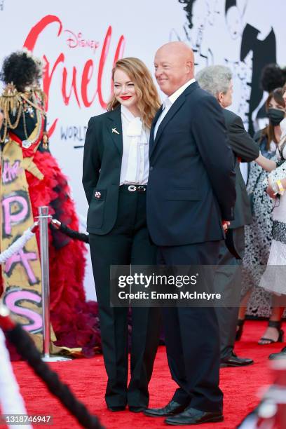 Emma Stone and Disney CEO Bob Chapek attend the Los Angeles premiere of Disney's "Cruella" at El Capitan Theatre on May 18, 2021 in Los Angeles,...