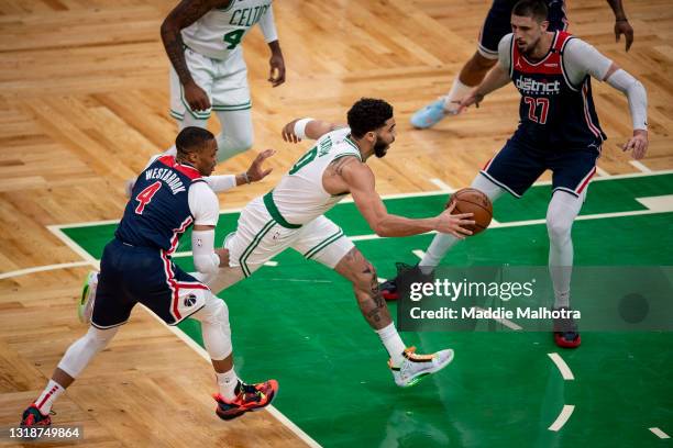 Jayson Tatum of the Boston Celtics drives to the basket during the first half of a game in the play-in tournament against he Washington Wizards at TD...
