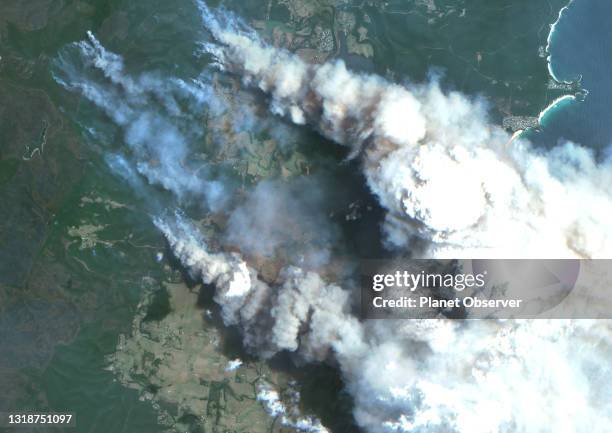 Color satellite image of bushfires in Batemans Bay on the South Coast region of New South Wales, Australia. Image collected on December 31, 2019 by...