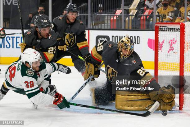 Marc-Andre Fleury of the Vegas Golden Knights defends the net against Ryan Hartman of the Minnesota Wild as he is tripped by Alec Martinez of the...