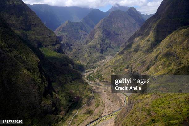 Reunion, Saint-Paul, : top of the caldera Cirque de Mafate and the river Riviere des Galets in the distance viewed from the Canalisation des orangers...