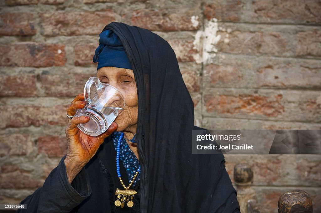 Senior woman drinking clean water in Egypt
