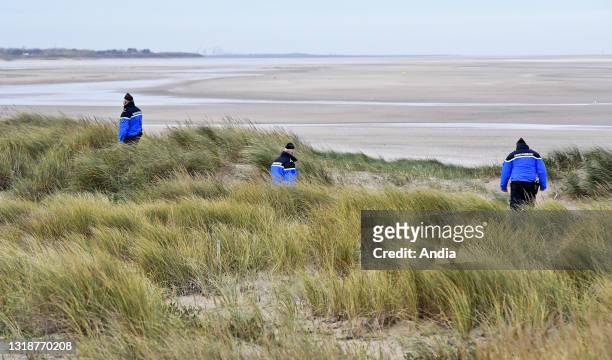 Surveillance of coastal areas by the police in Oye-Plage, along the cote d'Opale coastal area. Gendarmes on dunes checking if migrants attempt to...