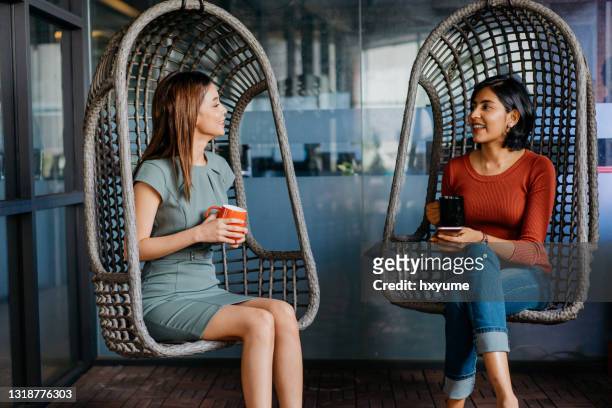 female office workers having a coffee break in office - coffee break office stock pictures, royalty-free photos & images