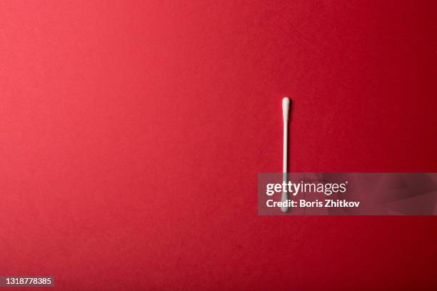 cotton swab over red background. - cotton bud stock pictures, royalty-free photos & images