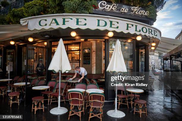 Waiter Olivier prepares the tables on the terrace at Cafe de Flore in Paris, as Cafes and Restaurants across France open for the first time in over 6...