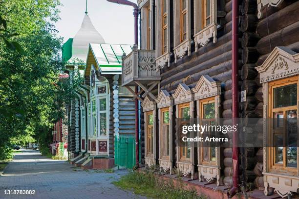 Street with traditional ornate wooden houses in the city Tomsk, Tomsk Oblast, Siberia, Russia.