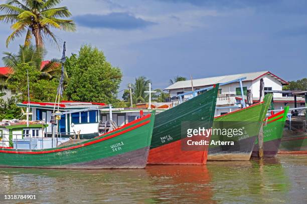 Traditional colourful wooden fishing boats in the harbour of New Amsterdam / Nieuw Amsterdam along the Suriname river, Commewijne District, Suriname.