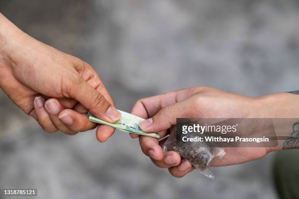 drug addict buying narcotics and paying - illegal drugs at work stock pictures, royalty-free photos & images