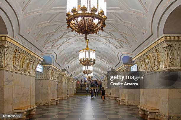 Arches in white marble and topped with ceramic bas-relief friezes inside the Prospekt Miro metro station of Koltsevaya line in city Moscow, Russia.