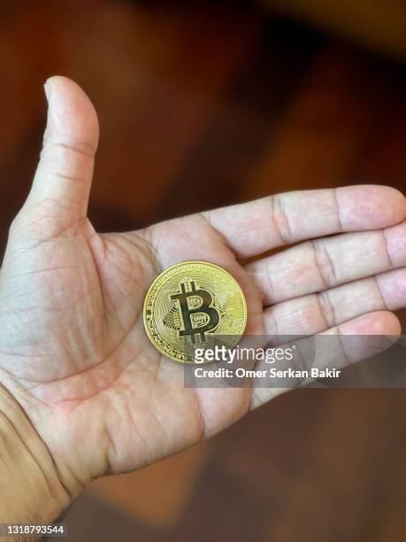 bitcoin in the palm of a hand - coin in palm of hand stock pictures, royalty-free photos & images
