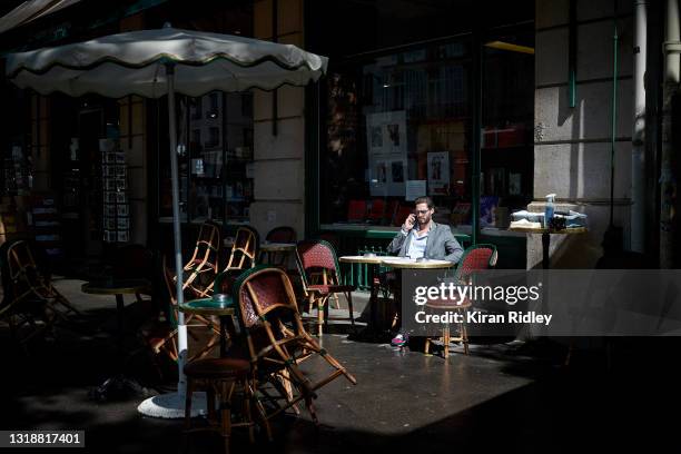 Parisian sits in the extended terrace at Cafe de Flore in Paris as Covid-19 restrictions are lifted allowing Cafes and Restaurants across France to...