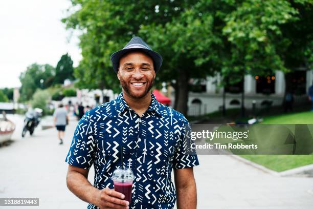 portrait of man holding fruit smoothie - mid adult stock pictures, royalty-free photos & images