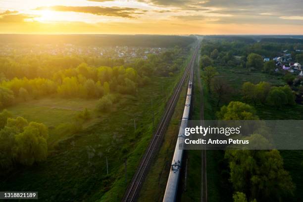 freight train on the railroad at sunrise. aerial view - voyage train stock pictures, royalty-free photos & images