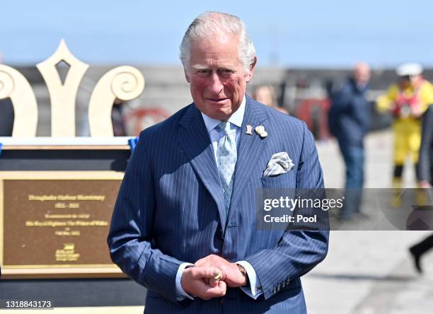 Prince Charles, Prince of Wales unveils a plaque to commemorate the Bicentenary of the Royal Charter of Donaghadee Harbour and the laying of the...