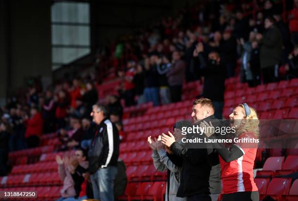 Barnsley fans applaud the team as they take to the field during the Sky Bet Championship Play-off Semi Final 1st Leg match between Barnsley and...